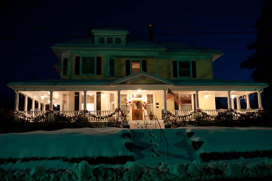 Elizabeth Leigh Inn at night with the porch lit and snow on the ground