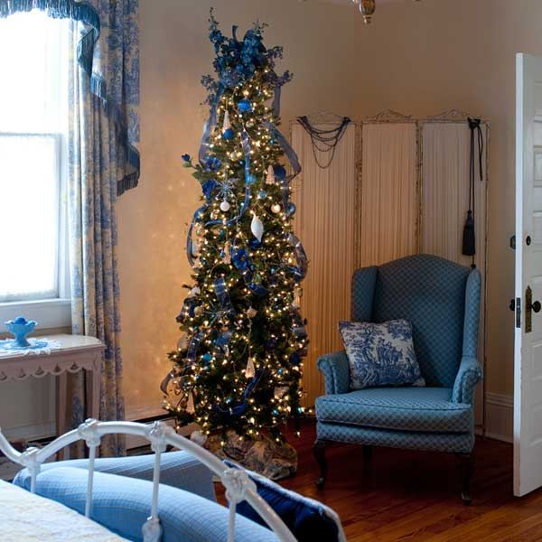 A corner of the Blue Room with a wingback chair by the window