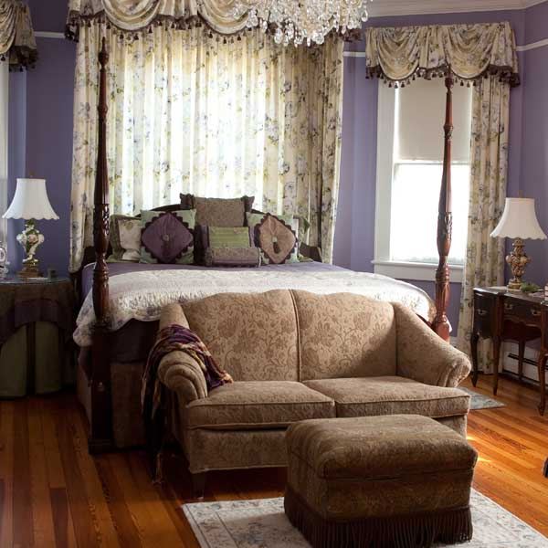 Another view of the Lavender Room with its sofa and four poster bed