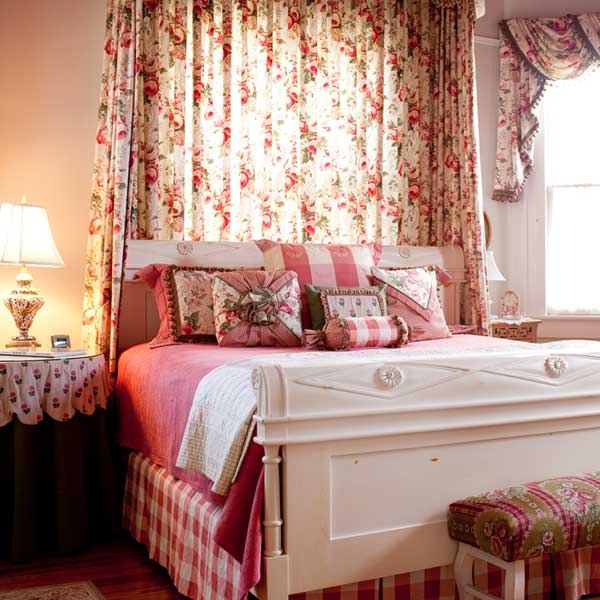 The Sage Room with a white king sleigh bed and floral curtains